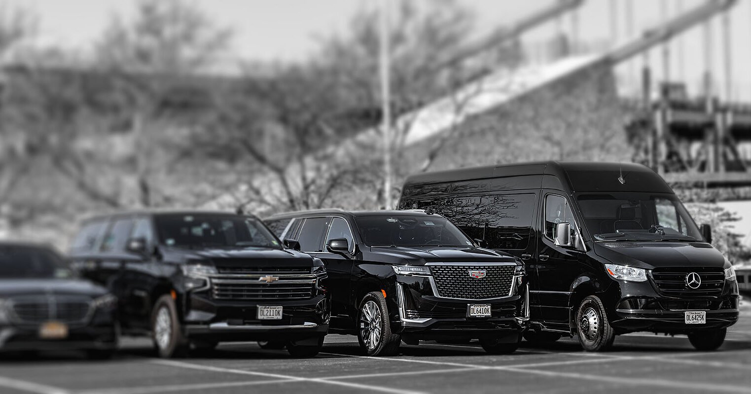 Luxury Black Car Chauffeured Fleets - Chevy Suburban, Cadillac Escalade, and Mercedes-Benz Sprinter Van A fleet of sleek black luxury vehicles, including a Chevrolet Suburban, a Cadillac Escalade SUV, and a Mercedes-Benz Sprinter executive passenger van parked together.