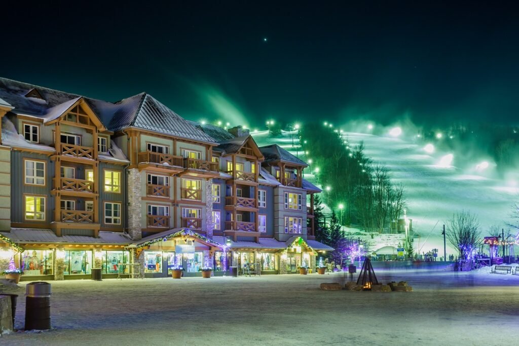 A scenic view of Blue Mountain Village in Ontario with shops, restaurants, colorful buildings, and visitors walking through the pedestrian village.