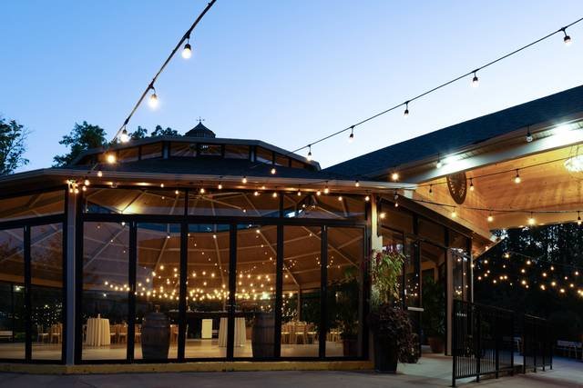 Glass wedding pavilion with warm string lights at dusk in Niagara-on-the-Lake